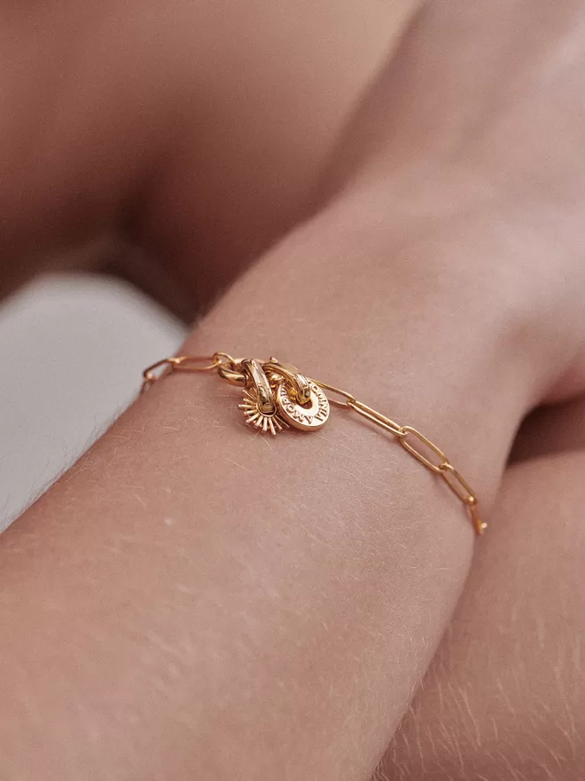 woman wearing gold bracelet with charms