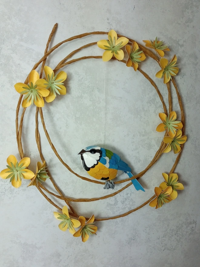 Front view of a blue tit sculpture wall hanging.