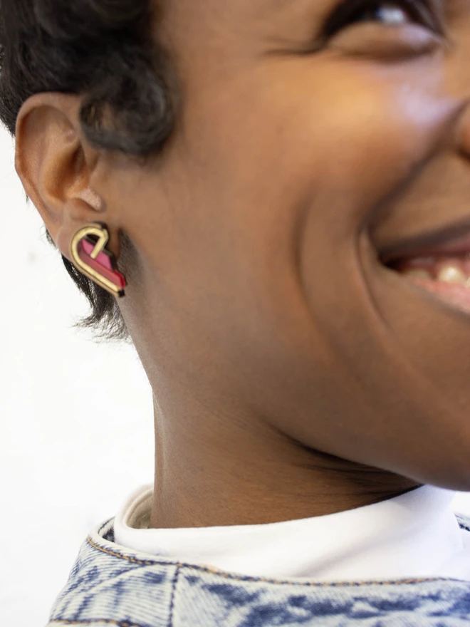 red half heart earring on person