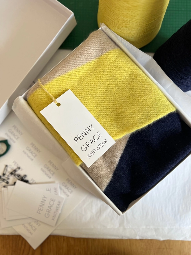 Knitted yellow navy oatmeal stripe scarf shown in gift box