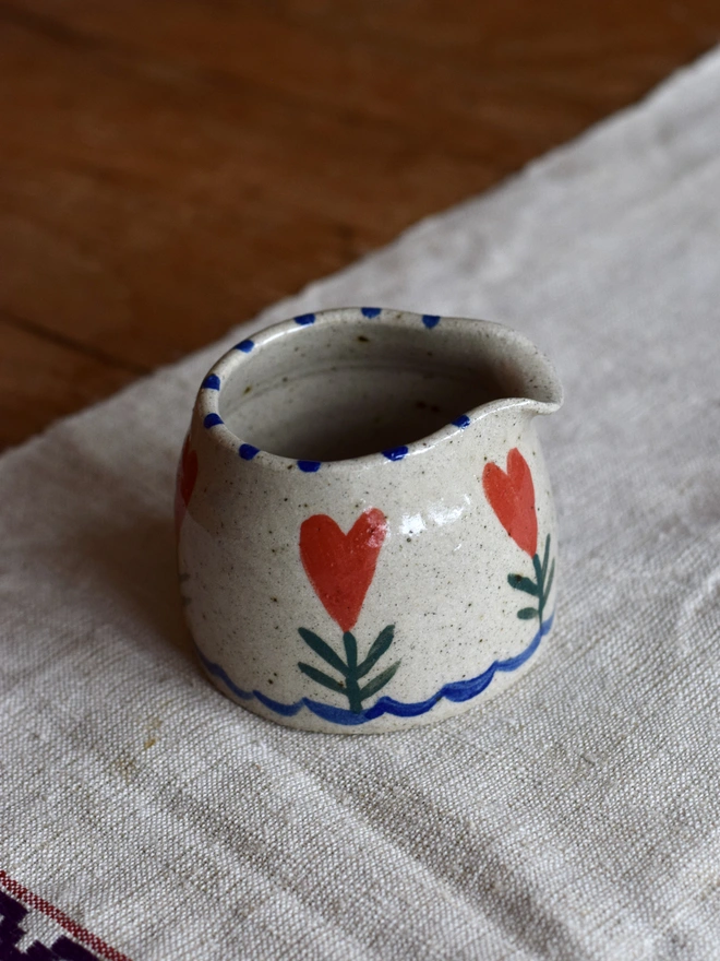handmade ceramic jug with heart pattern