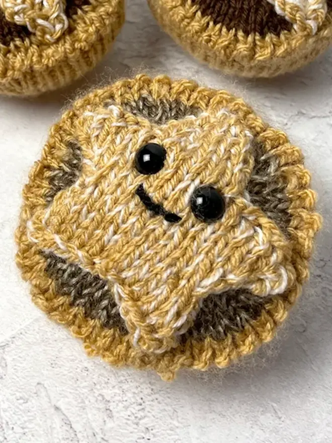 mini knitted mince pie with smiling face