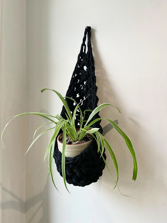 indoor medium black recycled cotton hanging wall planter, fabric wall mounted plant holder, handmade crochet plant basket, handmade sustainable crochet decor, rustic natural organic homeware accessories, black hanging plant holder with hook to hang