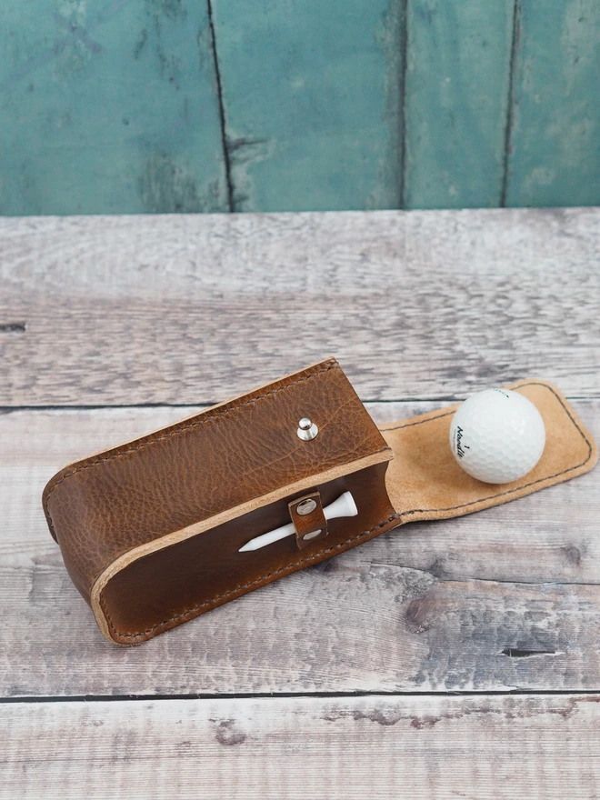 Handmade leather golf ball and tee carry case. A simple leather pouch designed for golf accessories.