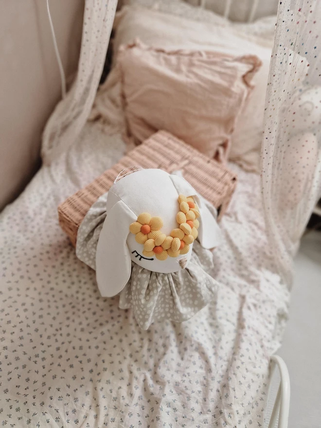 Rabbit Head Wall Mount, a cotton rabbit head wall decoration in a child's bedroom accompanied by other bedroom accessories. 