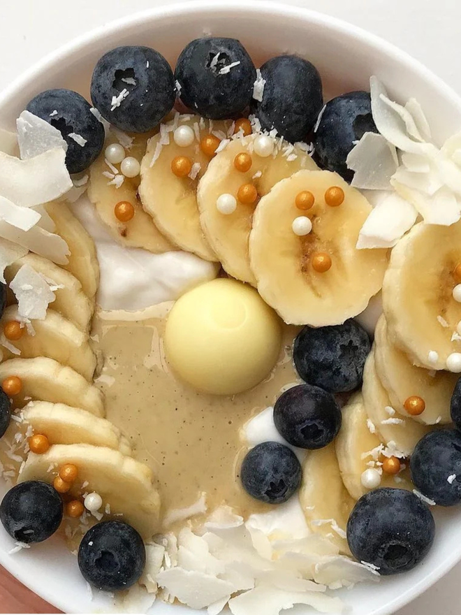coconut cardamom cashew butter. a bowl of porridge topped with fruit and creamy coconut cashew butter.