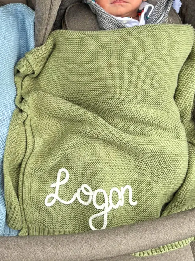 Hand-embroidered green baby blanket