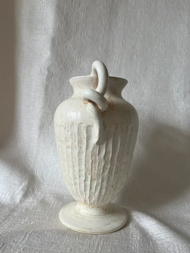 side angle of Urn Vase on white cloth background