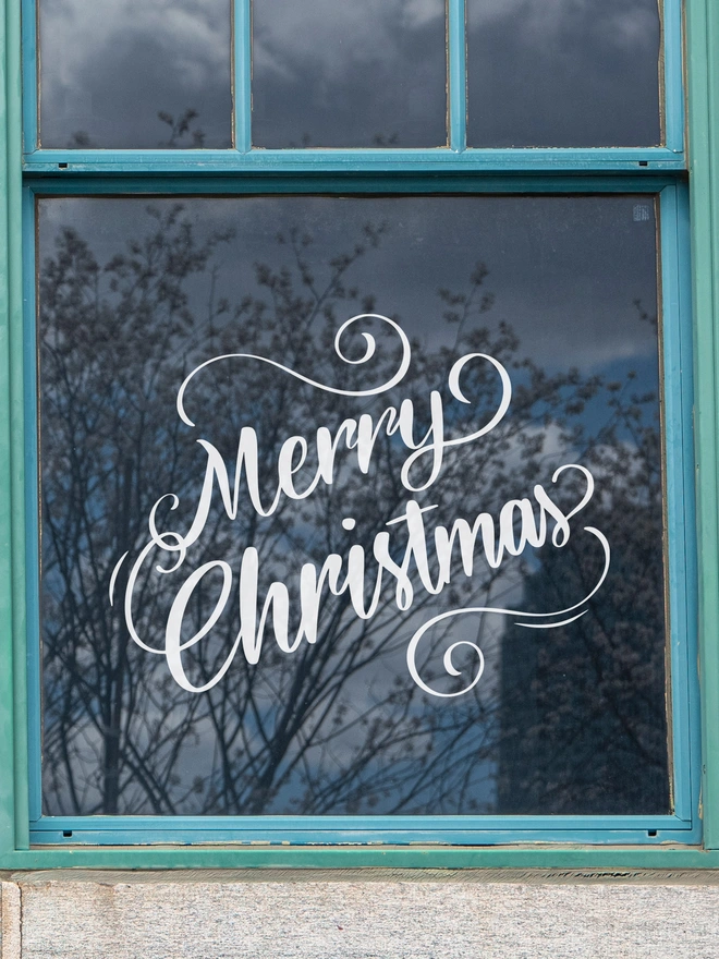 vintage style merry christmas sticker on a window