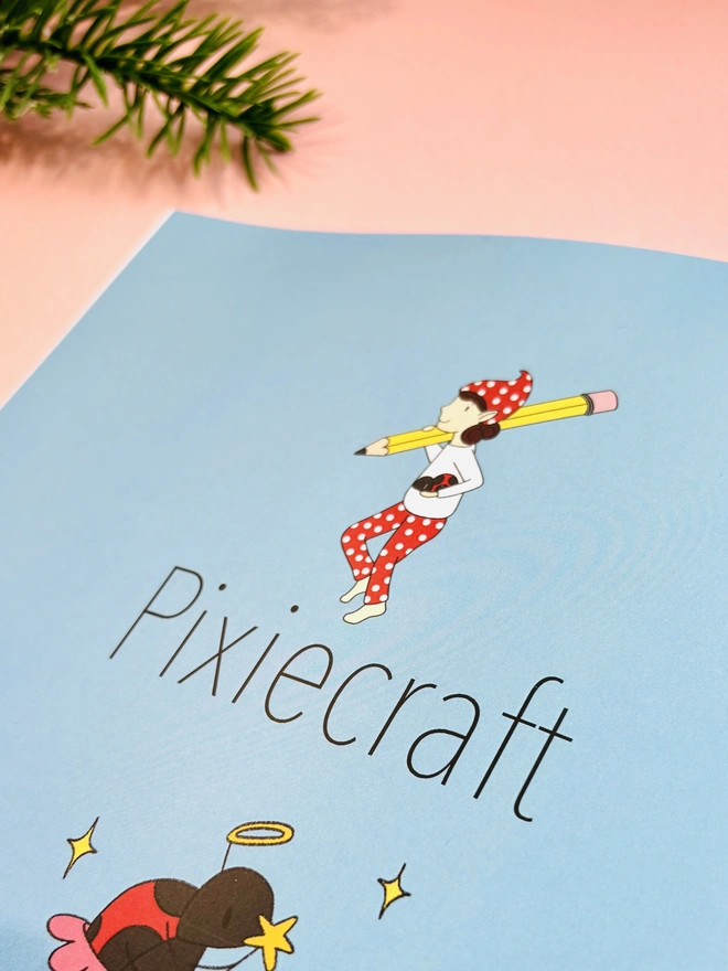 Woodland Christmas colouring book displayed with colouring pencils and winter decorations.