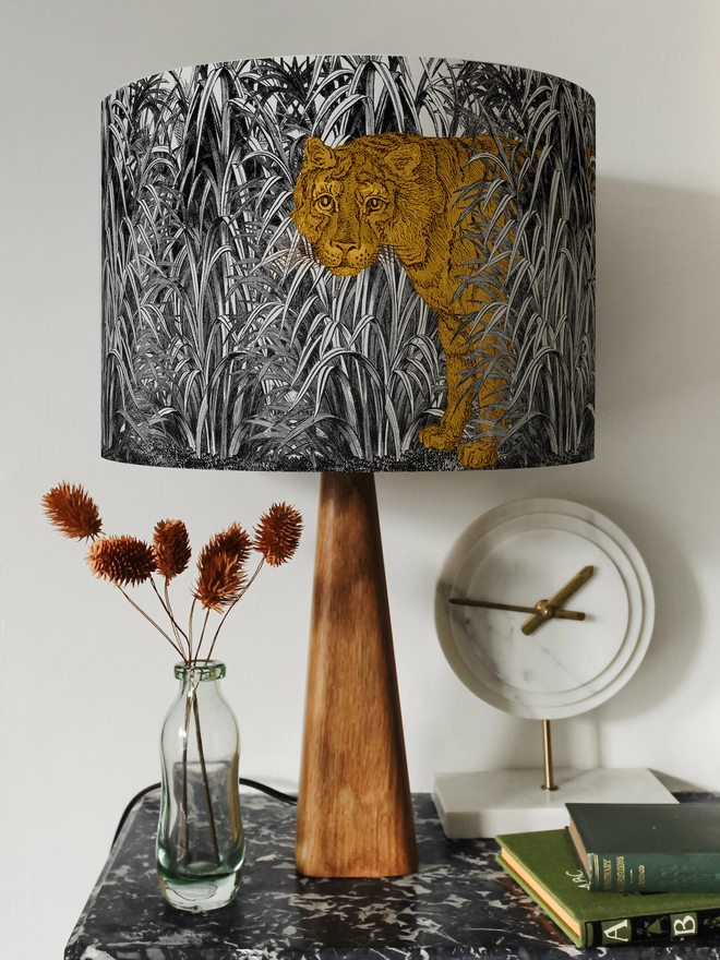 Mountain and Molehill – Tiger in leaves lampshade on wood base on a shelf with ornaments