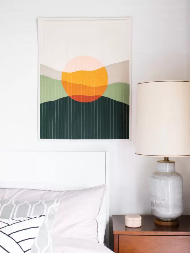 Westward Quilt Hanging On Wall Above Bed In Bedroom