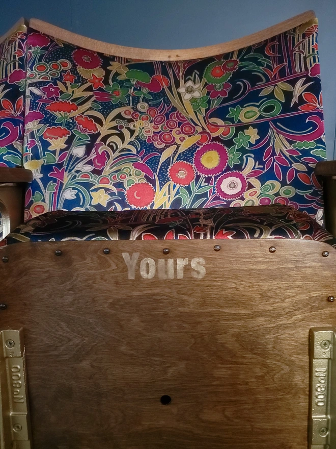 Vintage cinema seat with Yours stencilled under the seat