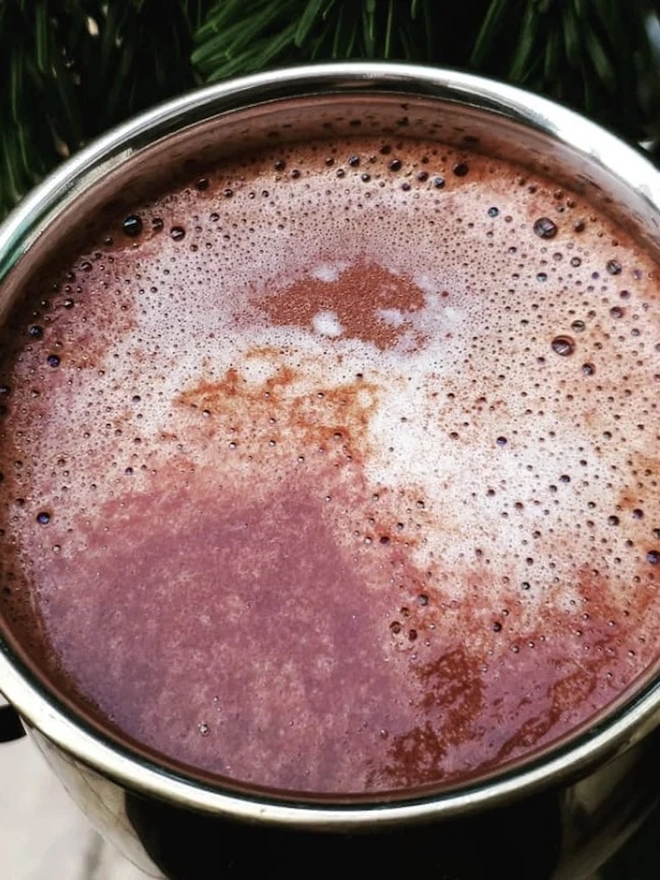 Drinking Chocolate 60% (Pack Of 200g/ 1kg), a hot chocolate sitting outside in a mug. 