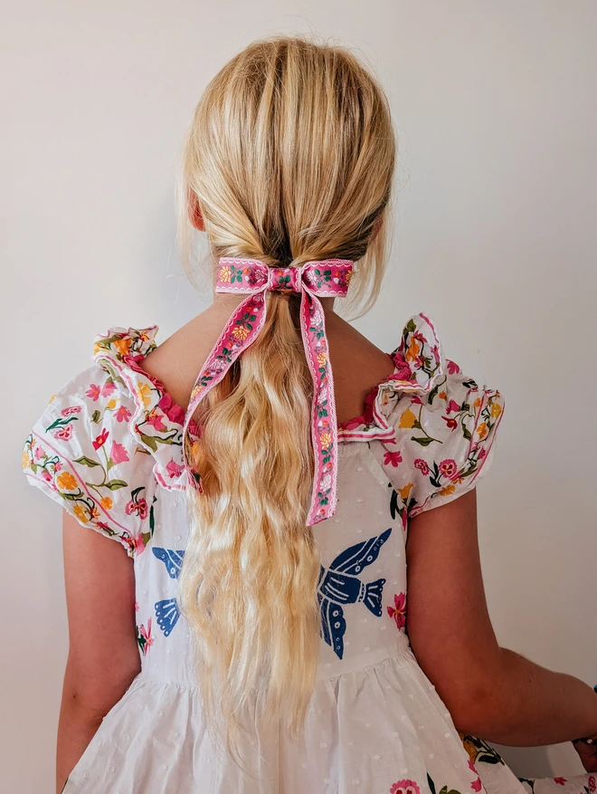 Girl with blonde hair wearing her hair bow