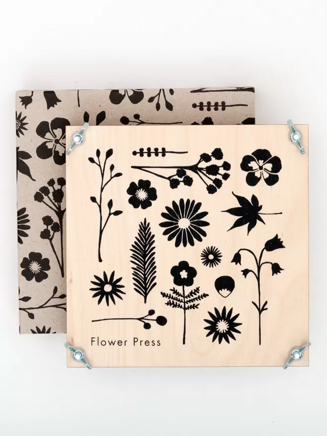 Flower press with floral illustrations on the front and matching illustrated packaging.