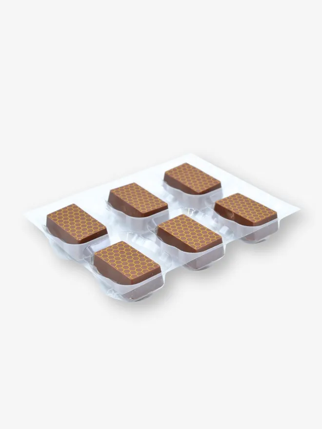 a tray of six luxury honey and saffron milk chocolates