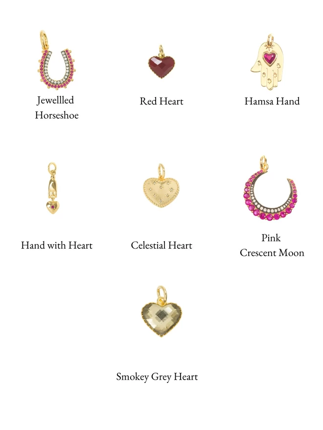 Selection of pink and pink moon, heart and horseshoe lucky talisman charms on a white background