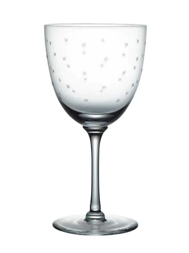 engraved stars large crystal wine glasses. a large wine glass patterned with small stars.