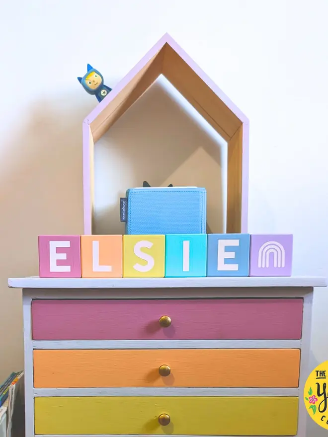 personalised hand-painted name blocks. the name 'elsie' spelt in different coloured square blocks.