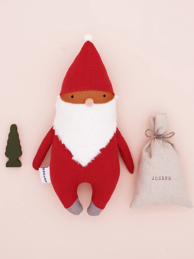 father christmas doll with brown skin and red outfit and personalised sack 