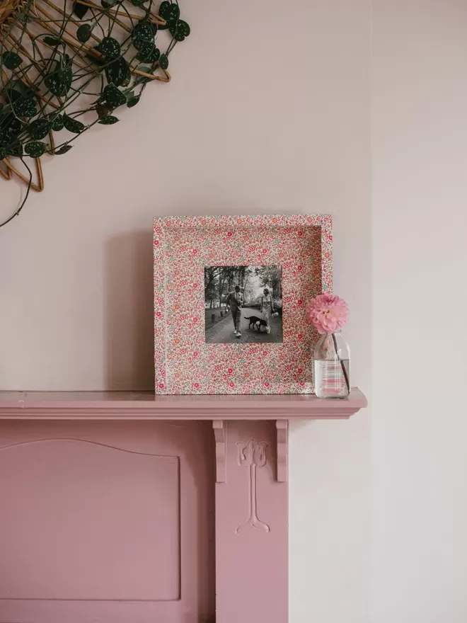 Liberty Fabric Covered Photo Box Frame seen on a pink mantlepiece.