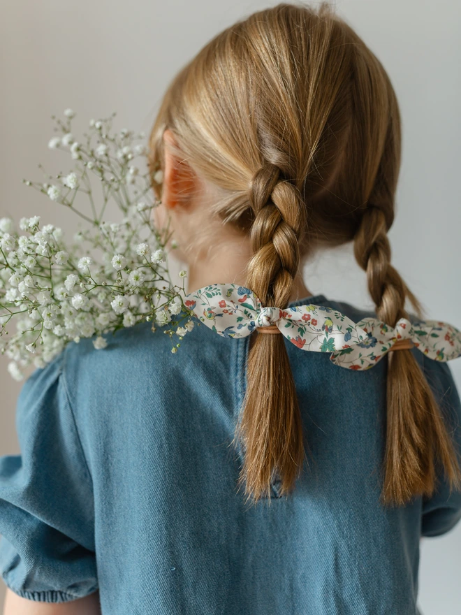 Girl wearing hair bobbles with flowers