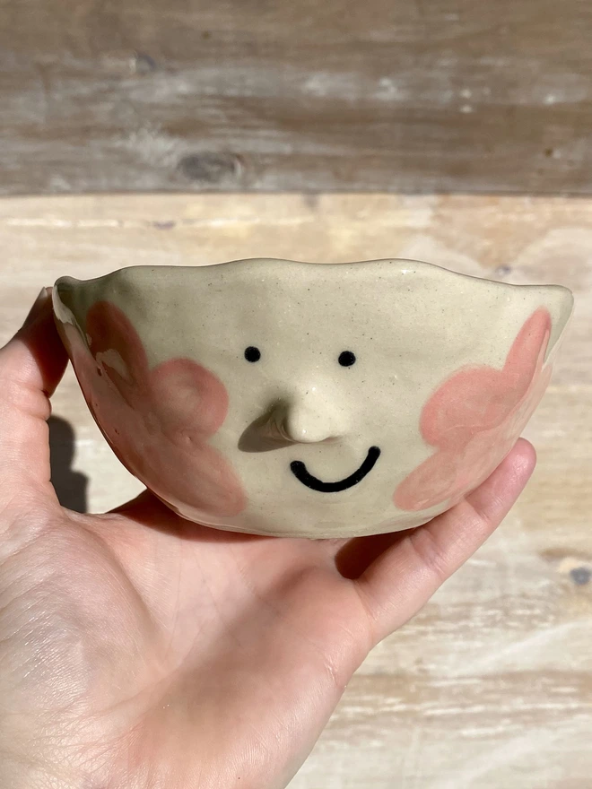 pink daisy ceramic pot - held