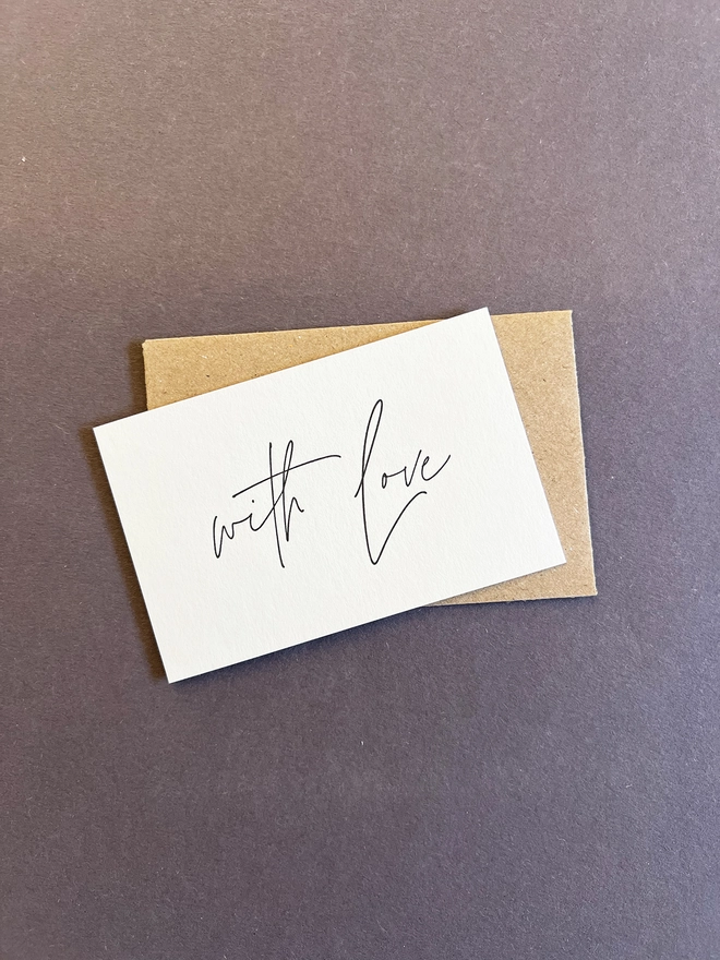 'With love' tiny note on top of a brown envelope.