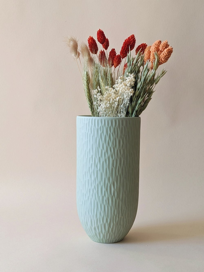 handmade textured pale blue vase with dried flowers