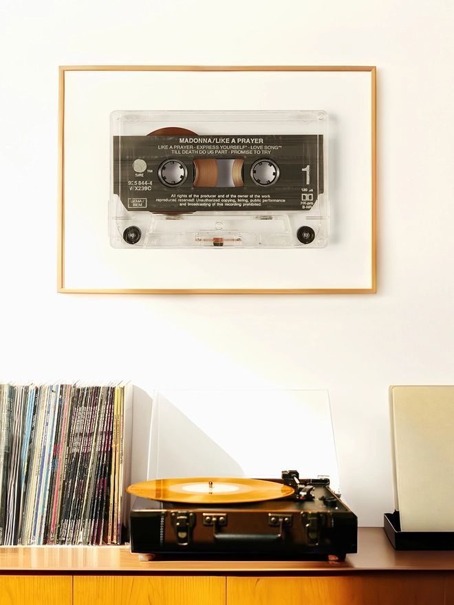 like a prayer madonna cassette tape print. framed print hung up above record player and vinyl collection.