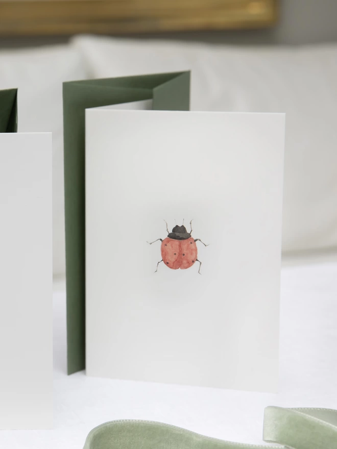 Greetings card with a watercolour illustration of a Ladybird comes with an olive green envelope