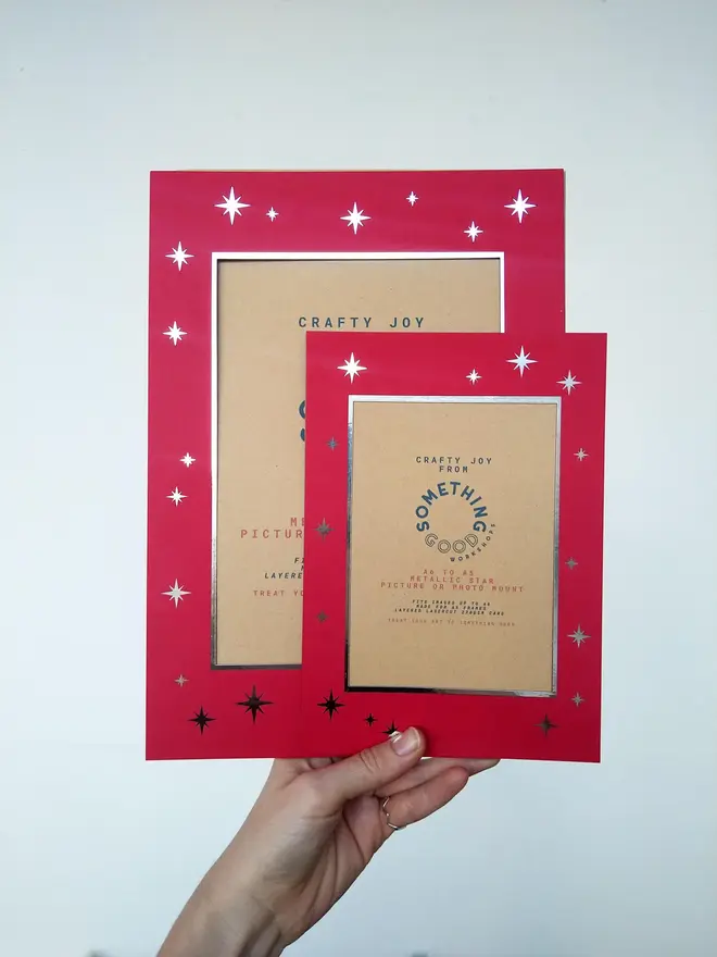 metallic star a5 / a4 christmas photo mount. red mount photographed against grey background.