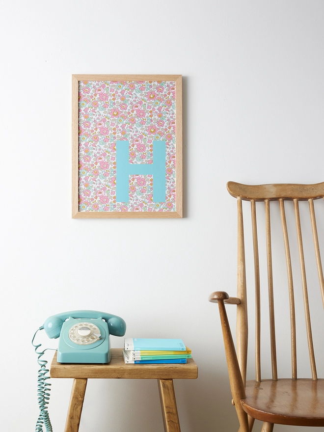 Personalised framed turquoise initial on Liberty Betsy pink fabric