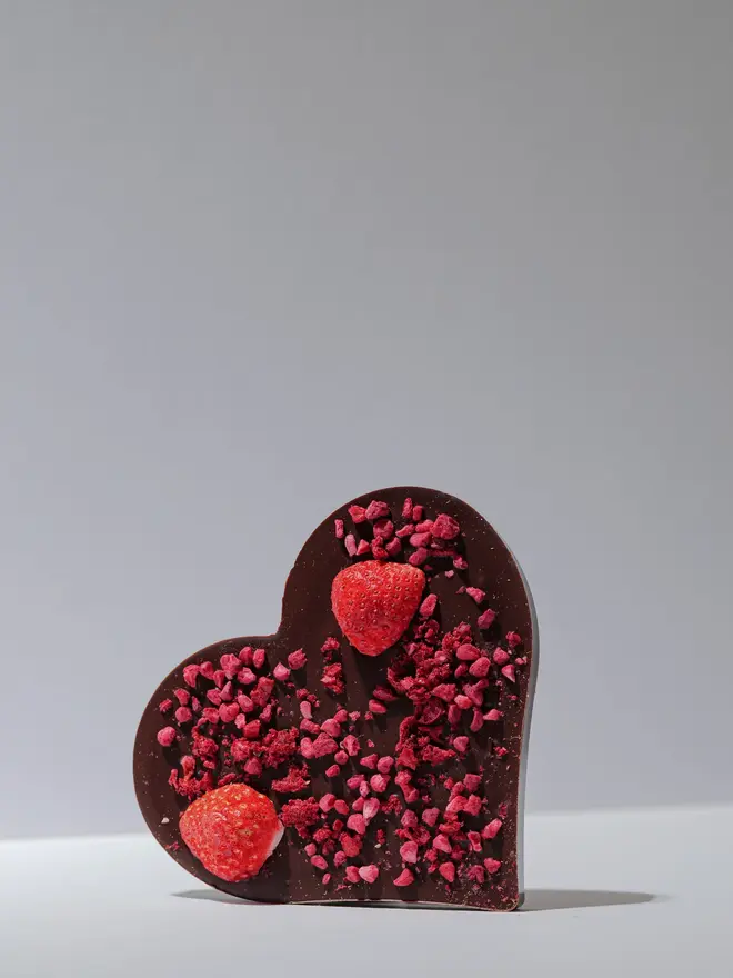 Dark chocolate & red berry heart on a white background. 
