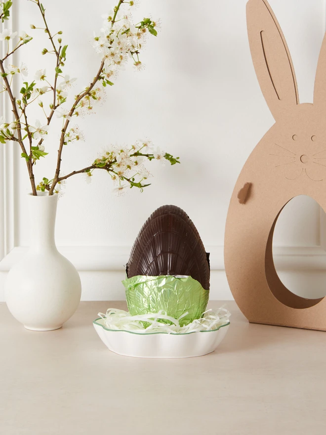 ginger dark chocolate easter egg 72%. a dark chocolate easter egg photographed partly unwrapped from green foil