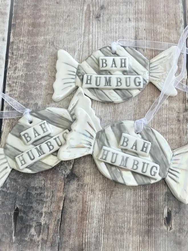 'Bah Humbug' Handmade Porcelain Sweet Christmas Decoration, trio of decorations above a table. 