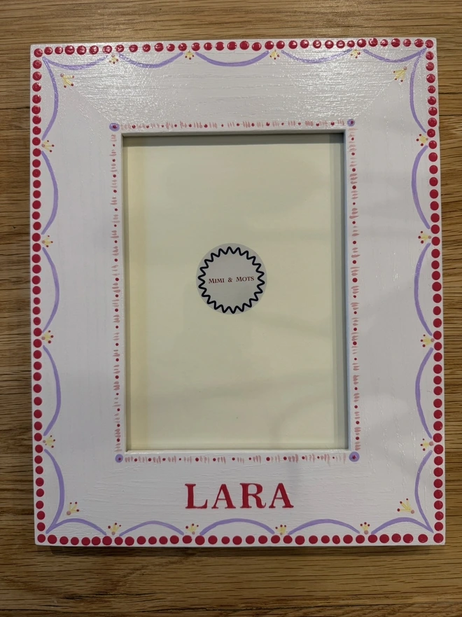 Wooden photoframe for children with pink detail. 