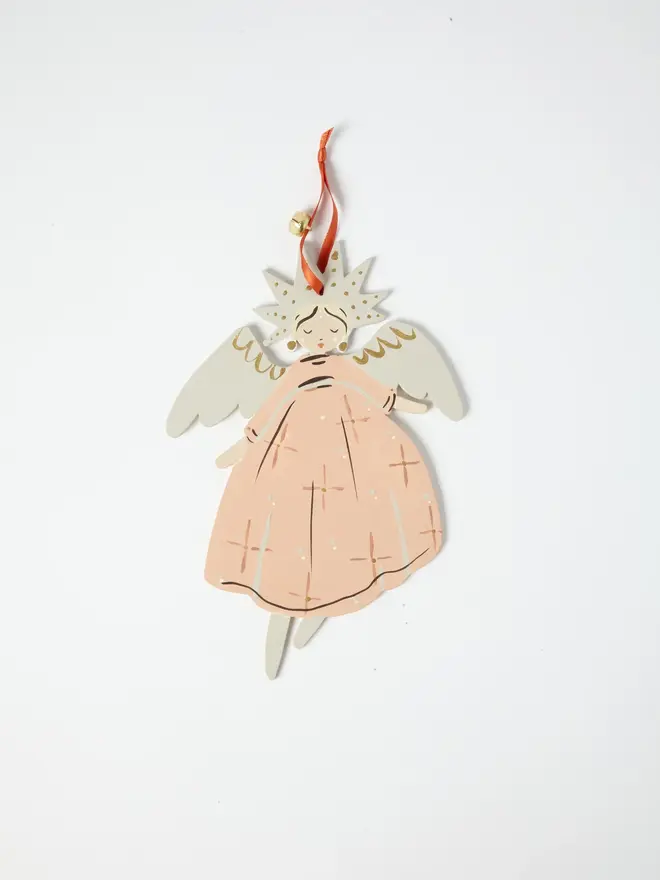 Angel Tree Dancer. wooden hanging angel decoration with a star-shaped gold-flecked halo, cream wings and peach star-patterned gown, orange ribbon with a jingle bell, on a white background