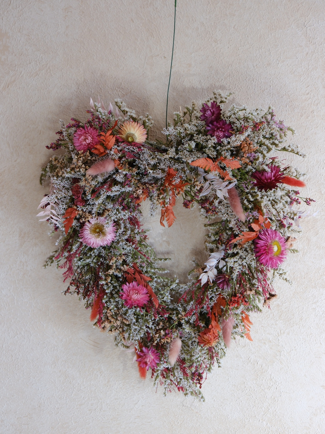 Pretty in pink heart wreath. A floral wreath with dried pink flowers in the shape of a heart