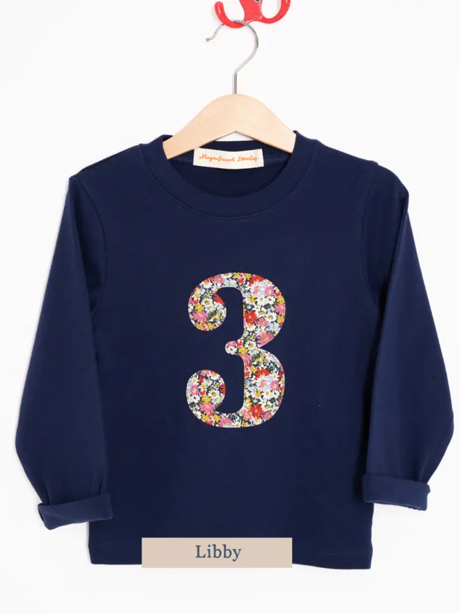 A navy birthday t-shirt with a number 3 cut from liberty floral print on the front