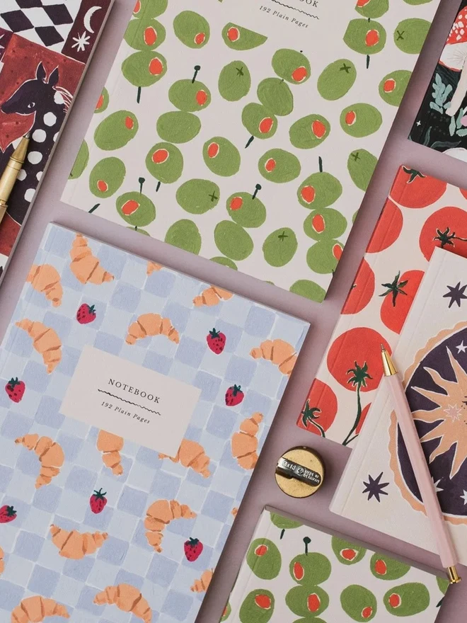 Croissant Cafe Notebook in a flat lay with other Sister Paper Co notebooks