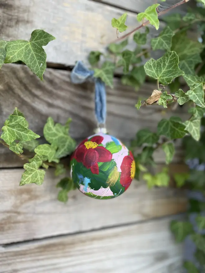  Unique hand-painted large ceramic floral Christmas bauble featuring red yuletide camellia flowers on a pale pink background
