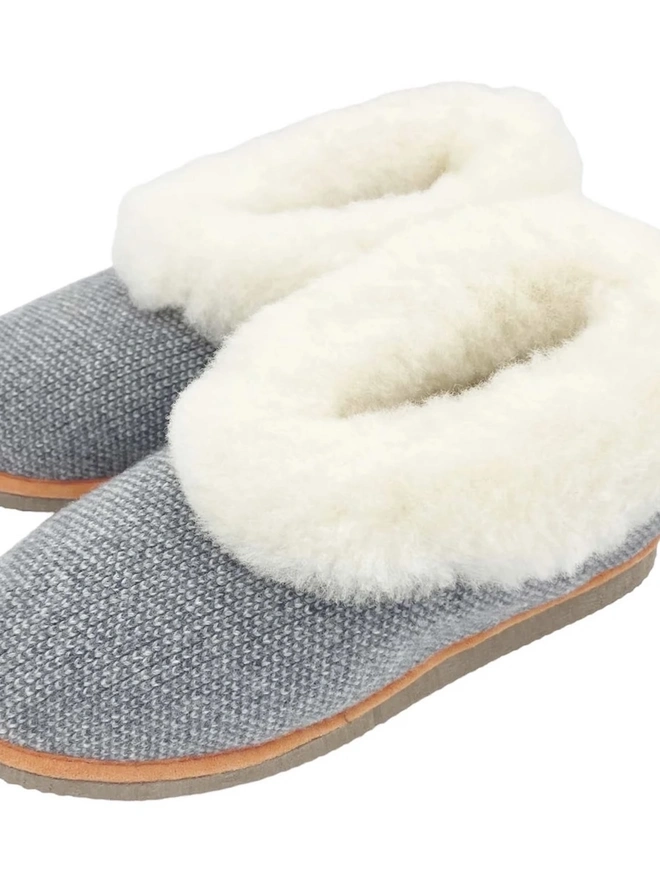 Lambswool & Sheepskin Slippers, a pair of colourful lambswool and sheepskin slippers sitting on a plain white surface. 