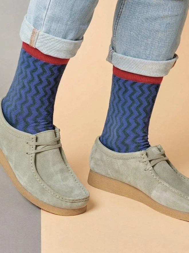 Men's Organic Cotton Ankle Socks Packs (Sets Of 3), a man wearing a pair of colourful patterned socks. 