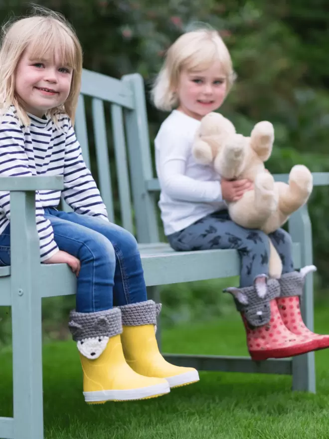 children wearing wellies with animal faces on wooly cuffs