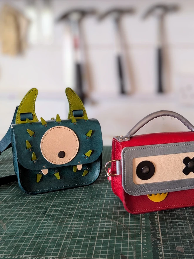 Monster cross- body bag pictured in workshop with Robot cross- body bag.