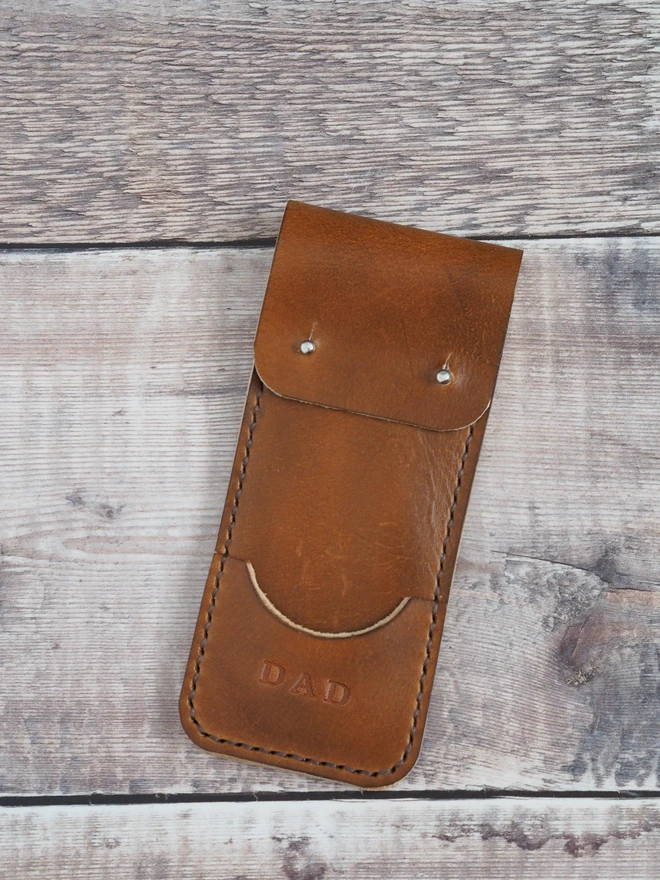 Personalised leather darts case. A tan brown leather sleeve, personalised with the name DAD.