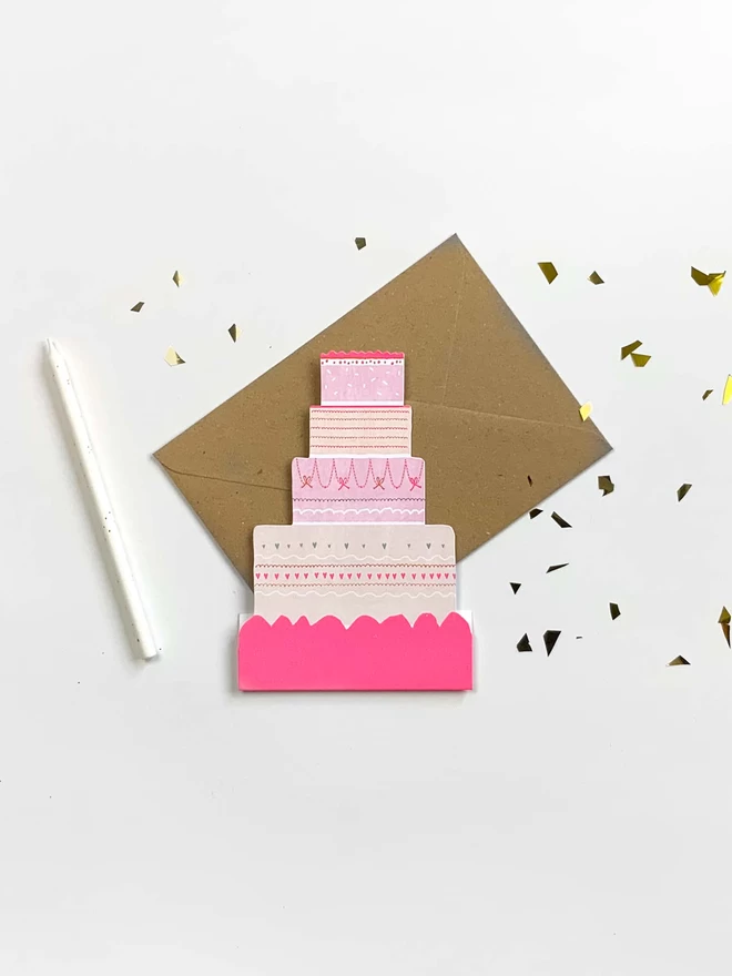 A Happy Cake celebration Card. Freestanding, die cut and neon with A6 kraft envelope.