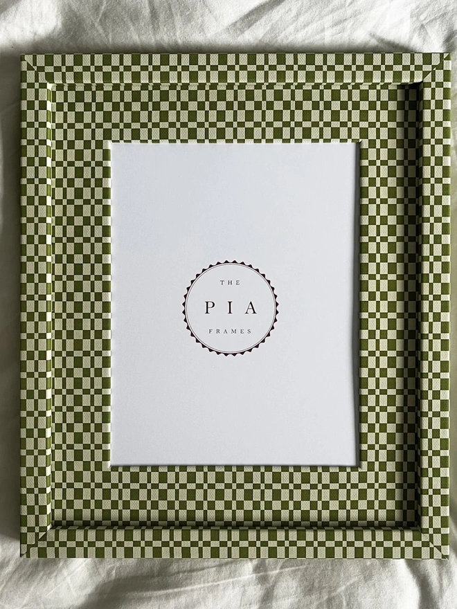 Green & Beige Checkered Frame, a colourful frame sitting on a plain white surface. 